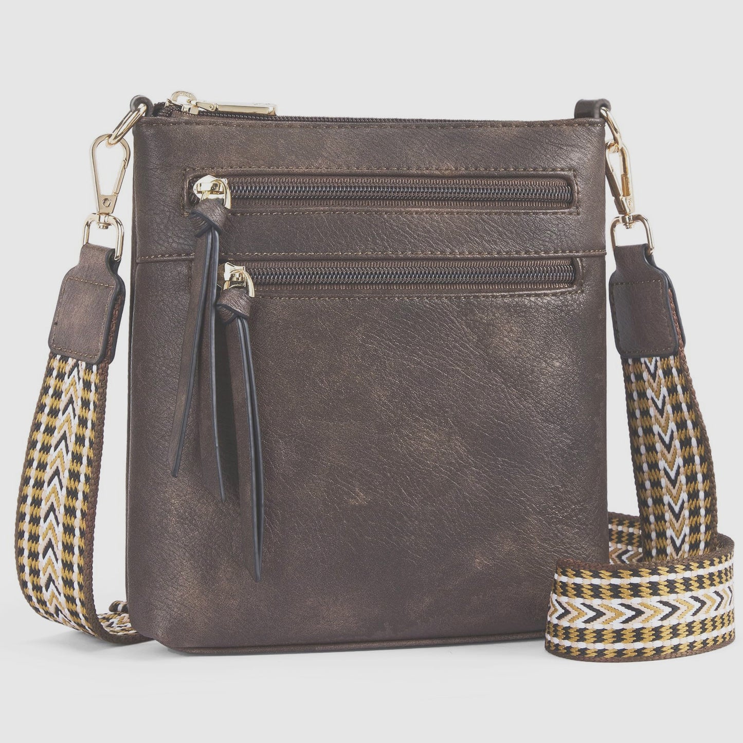 Sac bandoulière vertical pour femme avec plusieurs poches zippées.